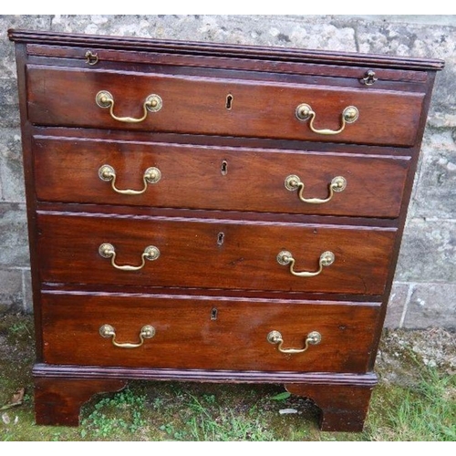 53 - A mahogany chest of drawers, fitted with a brushing slide, having four graduated long drawers, raise... 