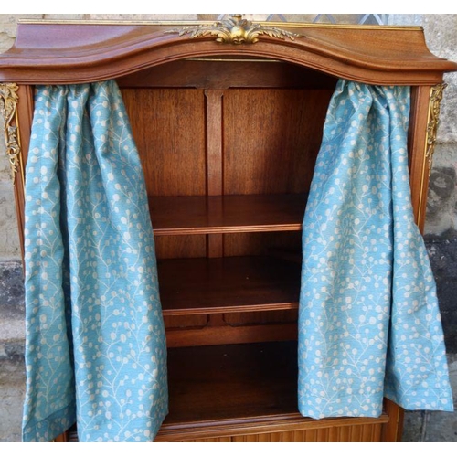 79 - A mahogany cabinet, fitted with shelves behind a pair of curtains, over a tambour front cupboard wit... 