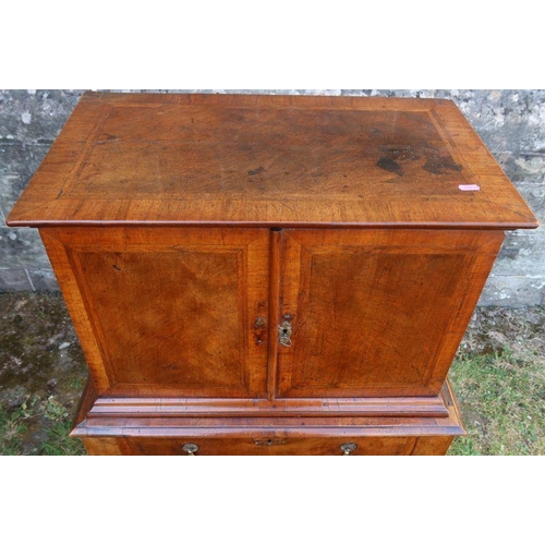 80 - An antique mahogany and cross banded chest on chest, the upper section fitted with a pair of cupboar... 