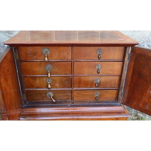 80 - An antique mahogany and cross banded chest on chest, the upper section fitted with a pair of cupboar... 