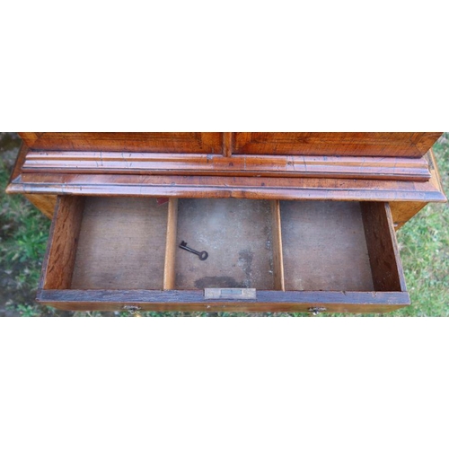 80 - An antique mahogany and cross banded chest on chest, the upper section fitted with a pair of cupboar... 