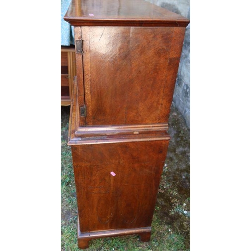 80 - An antique mahogany and cross banded chest on chest, the upper section fitted with a pair of cupboar... 