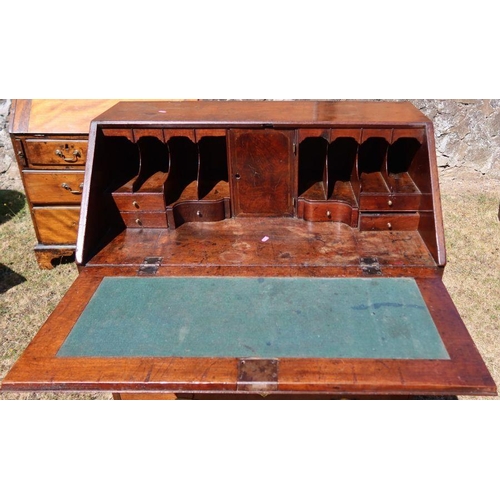 91 - An antique walnut and mahogany bureau, the sloping fall front opening to reveal cupboard, drawers, a... 