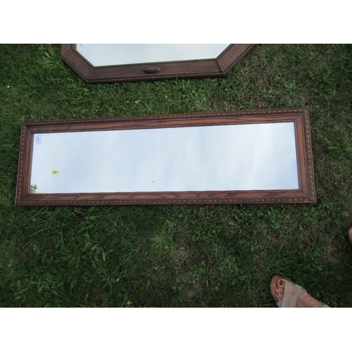 151 - An oak framed mirror, 39ins x 9.5ins together with two others