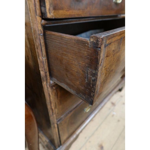 11 - An 18th Century walnut chest of drawers, having two short over three long drawers, raised on bracket... 