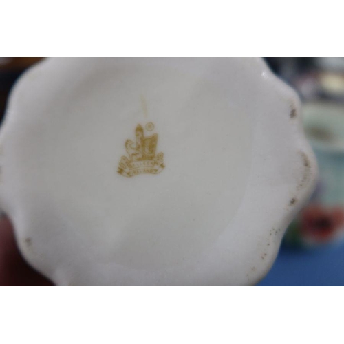 125 - A Belleek vase, formed as a flower, together with a Radford vase, decorated with flowers