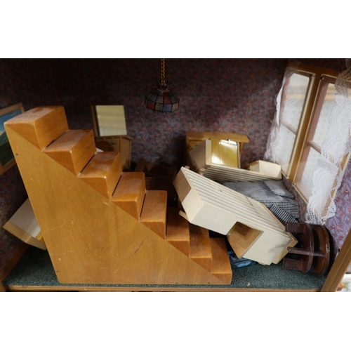 131 - A three storey dolls house, together with accessories