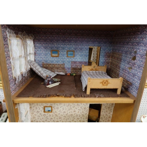 131 - A three storey dolls house, together with accessories