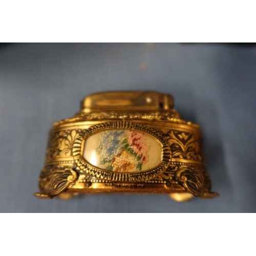 148 - A 19th century mahogany sarcophagus shaped tea caddy, together with a carriage clock and a lighter