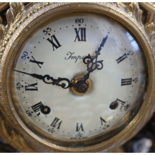 213 - A 20th century French style gilt metal mantel clock, in the empire style