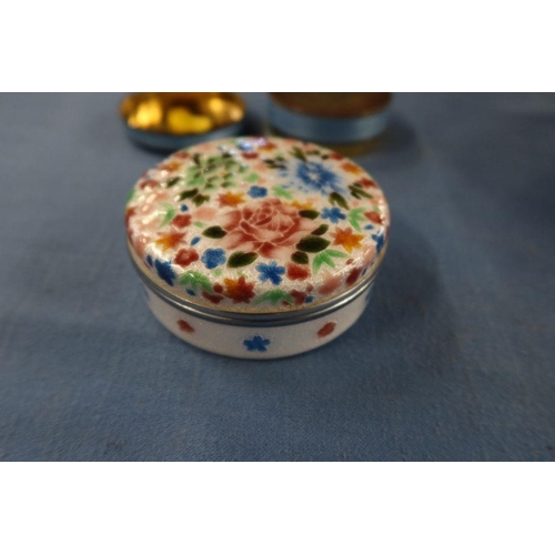 270A - A hallmarked silver and enamel circular box, with pull off cover, the cover decorated with fish and ... 