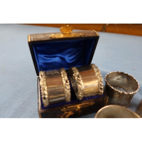 288 - A cased pair of hallmarked silver napkin rings, together with four other hallmarked silver napkin ri... 