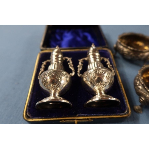 290 - A collection of hallmarked silver condiments, to include a cased pair of pepper pots, two covered mu... 