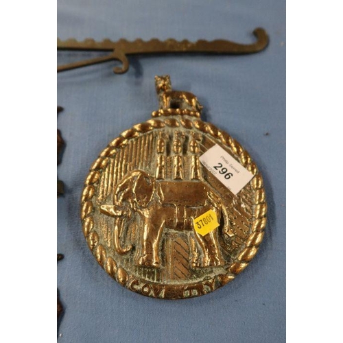 296 - A Coventry brass boat plaque, embossed with an elephant and a castle, together with a pair of ship o... 