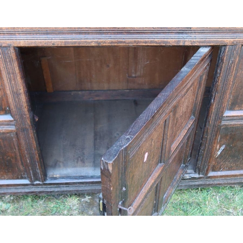 3 - An antique oak court cupboard, fitted with two cupboards to the upper section, and a central cupboar... 