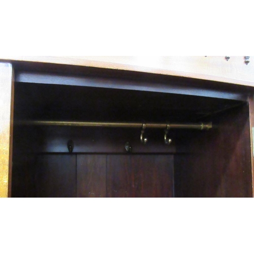 66 - A mahogany press cupboard, having two door opening to reveal hanging space over two drawers, width 4... 