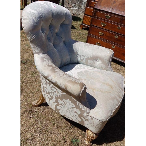 93 - A Victorian button back upholstered nursing chair, raised on short gilt legs, with carved decoration