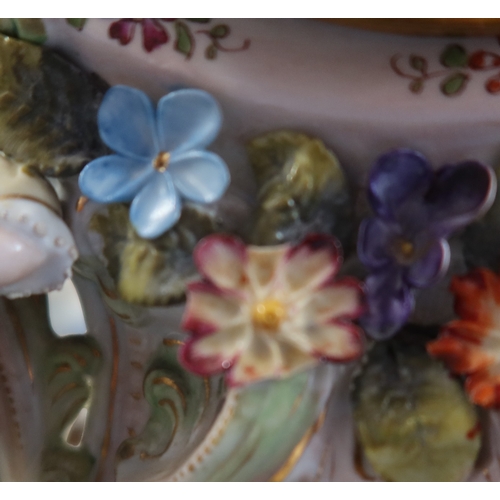 240 - A porcelain mantel clock, encrusted with flowers and two figures