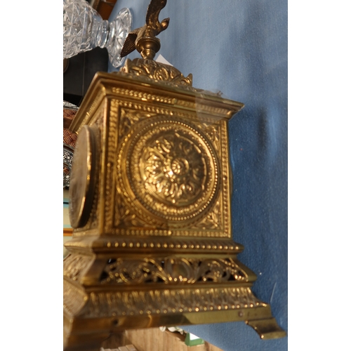 129 - A brass cased mantel clock, with eagle finial