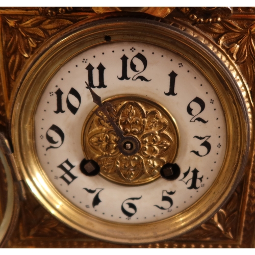 129 - A brass cased mantel clock, with eagle finial