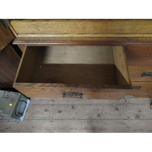 136 - An Arts and Crafts  light oak linen press, the two panel doors opening to reveal slide out trays,ove... 