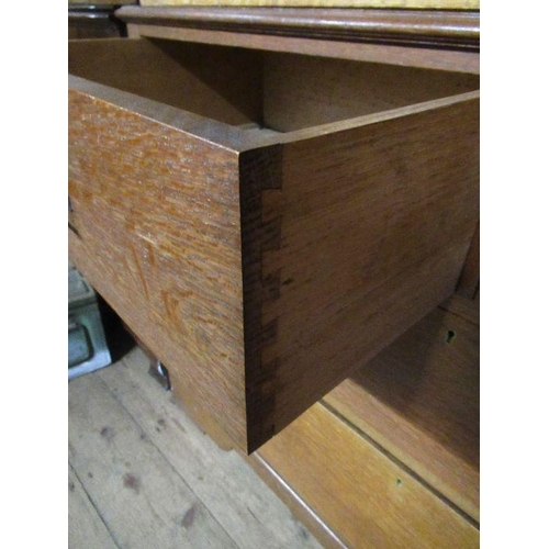 136 - An Arts and Crafts  light oak linen press, the two panel doors opening to reveal slide out trays,ove... 