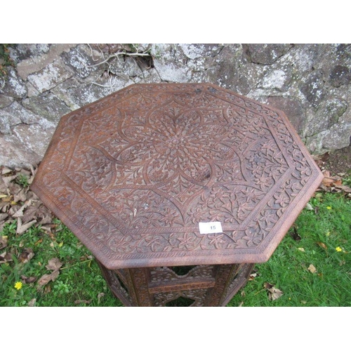 15 - An middle Eastern design octagonal table, with all over intricate carved decoration, width 24ins, he... 