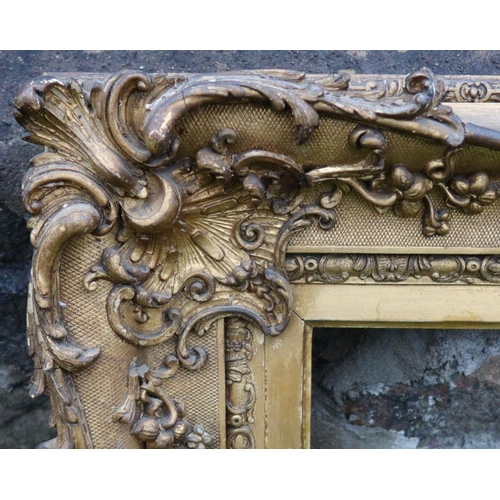 210 - Two 19th century gilt picture frames, with applied decoration, aperture size 36ins x 28.5ins