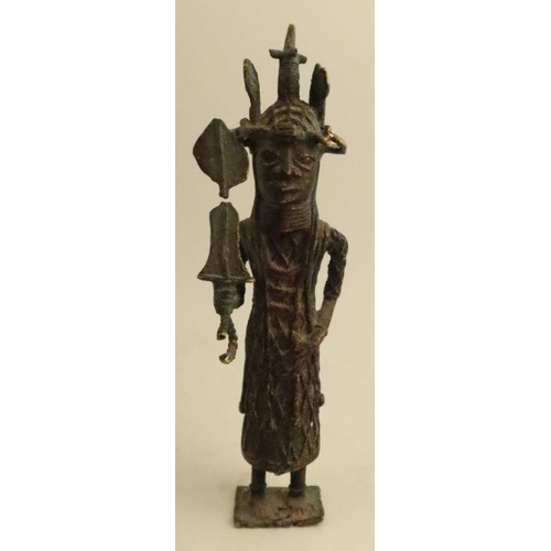 253 - A carved wooden African figure, together with another cast figure holding a shield