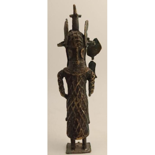 253 - A carved wooden African figure, together with another cast figure holding a shield