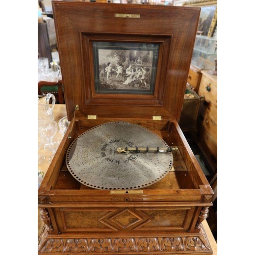 260 - A 19th century walnut and mahogany cased table top polyphon, with inlaid and carved decoration, toge... 