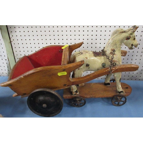 279 - A child's painted toy horse, on a plinth with wheels, pulling a cart, together with a doll and a Nor... 