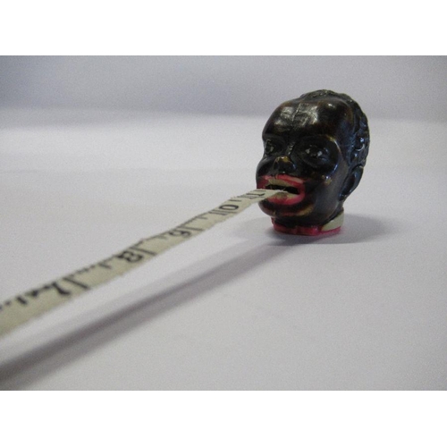 281 - A 1920s celluloid tape measure modelled as a man's head