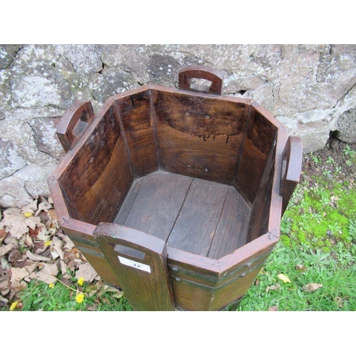 32 - An Arts and Crafts style oak planter, with metal banding, width 12.5ins, height 25ins