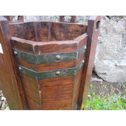 32 - An Arts and Crafts style oak planter, with metal banding, width 12.5ins, height 25ins