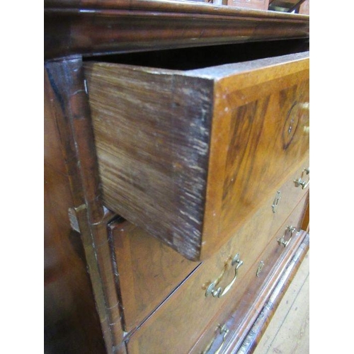 33 - An 18th century walnut chest on low stand,  having a quarter veneered cross banded top, over two sho... 