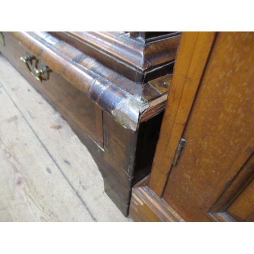 33 - An 18th century walnut chest on low stand,  having a quarter veneered cross banded top, over two sho... 