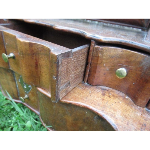 35 - An early 18th century design walnut toilet mirror, with stepped base fitted with three short and one... 