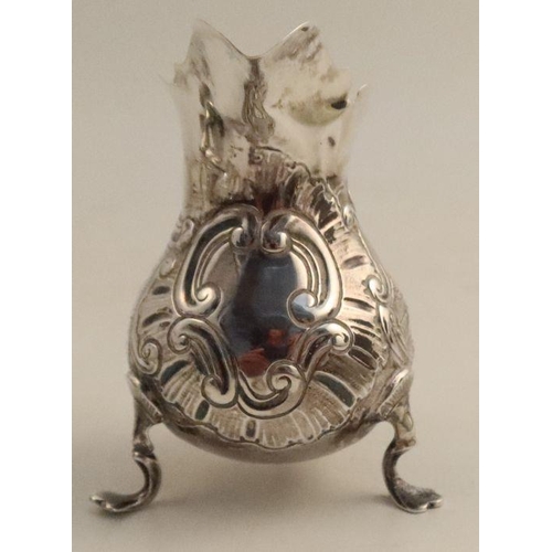 355 - A Georgian silver cream jug, of baluster form, the body embossed with scrolls, a hound and a bird, m... 