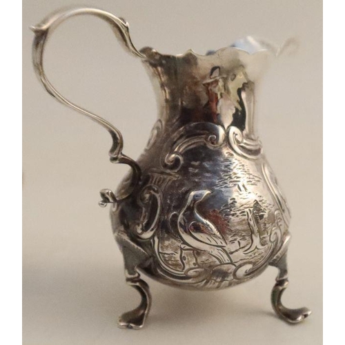 355 - A Georgian silver cream jug, of baluster form, the body embossed with scrolls, a hound and a bird, m... 