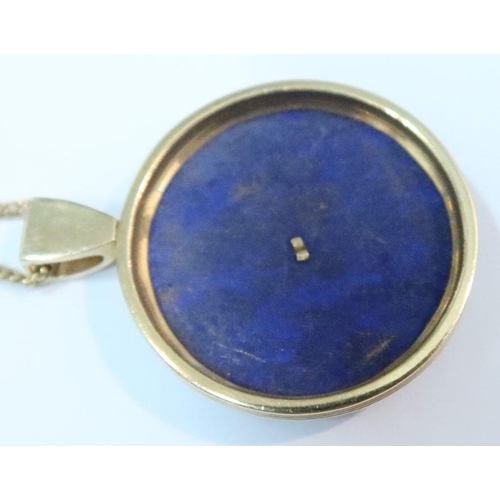 384 - A 14k gold and lapis lazuli pendant, on 14k fine link chain together with a lapis lazuli ring and a ... 