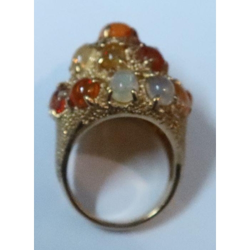 386 - A 14k dress ring with numerous fire opals and others