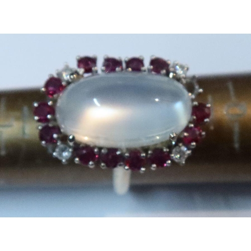 389 - A 14k white and moonstone ring, with a border of ruby and diamonds, 8.2g, together with a 14k yellow... 