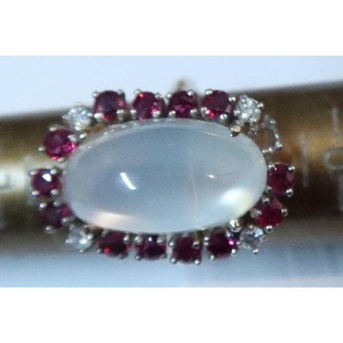 389 - A 14k white and moonstone ring, with a border of ruby and diamonds, 8.2g, together with a 14k yellow... 