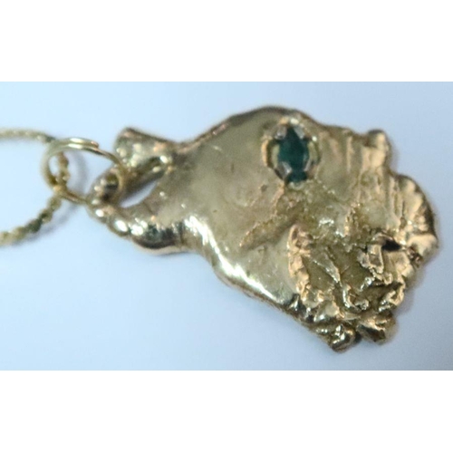 399 - A gold nugget pendant, set with marquise cut emerald, on fine 14k gold chain