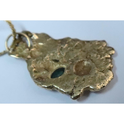 399 - A gold nugget pendant, set with marquise cut emerald, on fine 14k gold chain