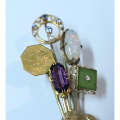 403 - A 14k gold brooch, having five pins with various finials, including amethyst, pearl and sapphire etc... 