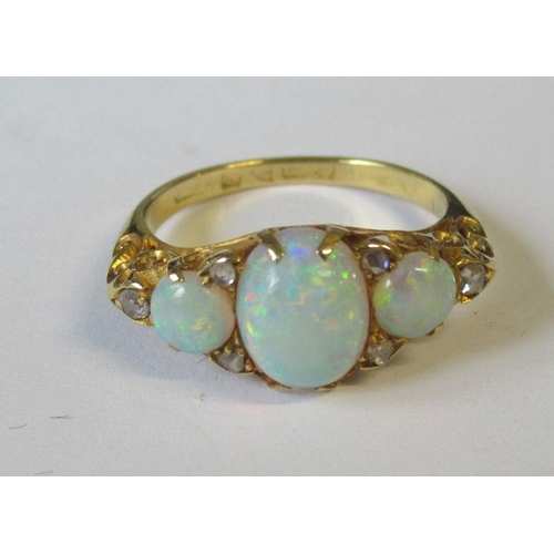 408 - An 18ct three stone opal ring with diamond accents, 3.9g