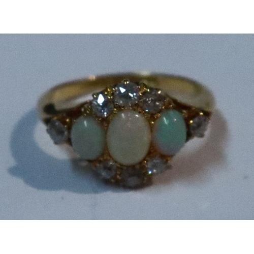 430 - An 18ct gold three stone opal and diamond ring