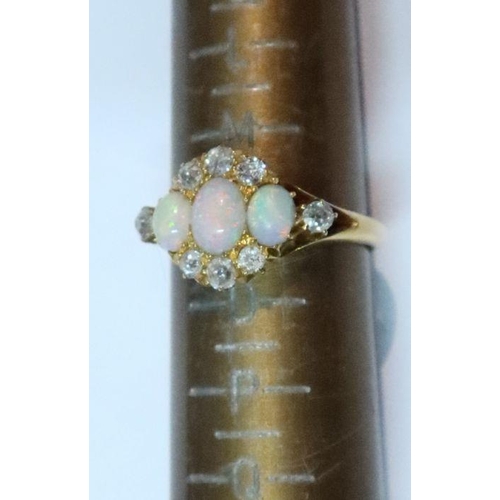 430 - An 18ct gold three stone opal and diamond ring